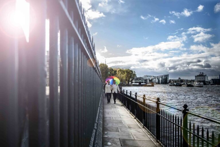 LGBTQ+ wedding portrait of two grooms outside the Trafalgar Tavern overlooking the Thames